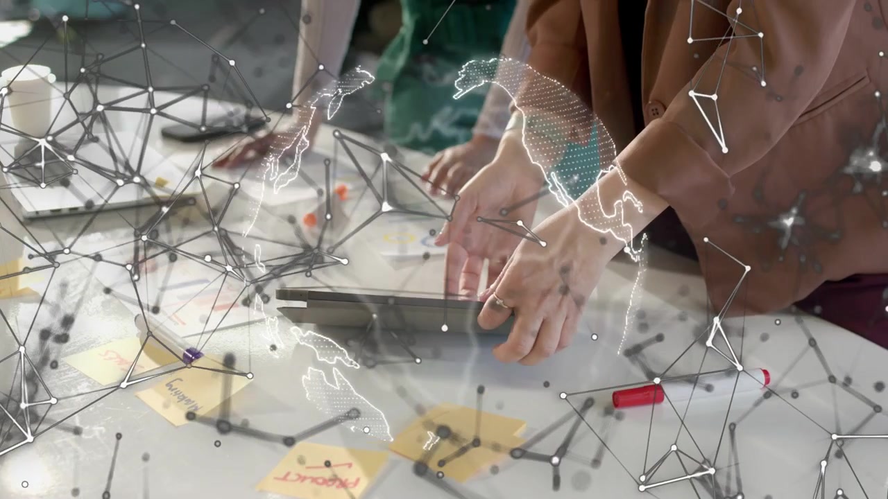 Lead woman tapping tablet and starting net globe overlay over hands while peer viewing design notes