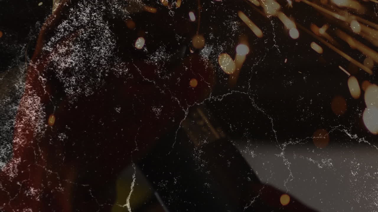 Graphic designer creating industrial workshop scene, overlaying animated sparks on scratched metal