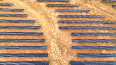 aerial-view-of-solar-farm-over-dry-land,-portugal,-4k