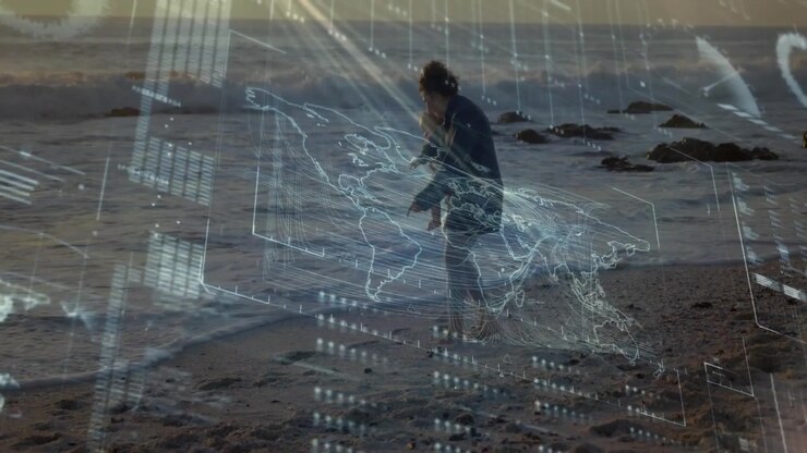 Reacting to holographic map, mother dark jacket pants carrying baby walking on wet sand near waves