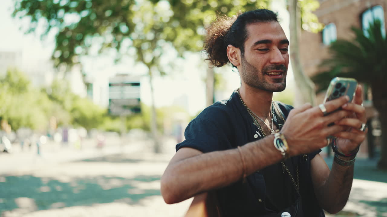 Man Using Phone in Urban Park