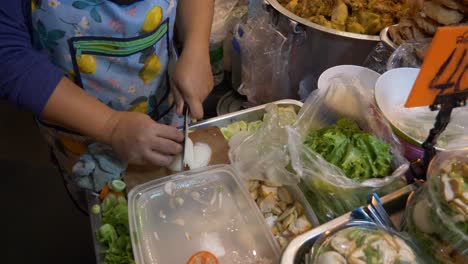 thailand temple night market street food booth cutting onion