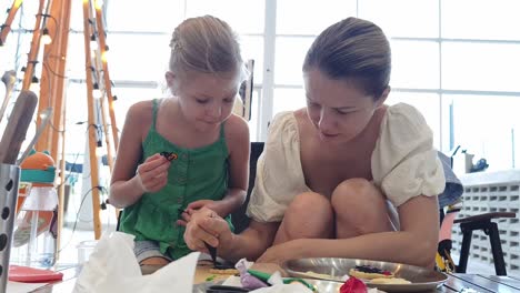 mother and daughter decorating cookies