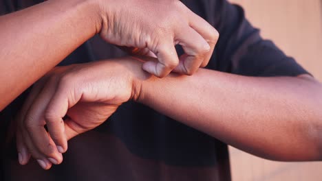 person scratching their arm