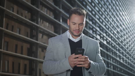 businessman using smartphone on street. worker browsing internet on phone