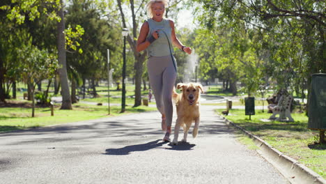 woman walking dog in park