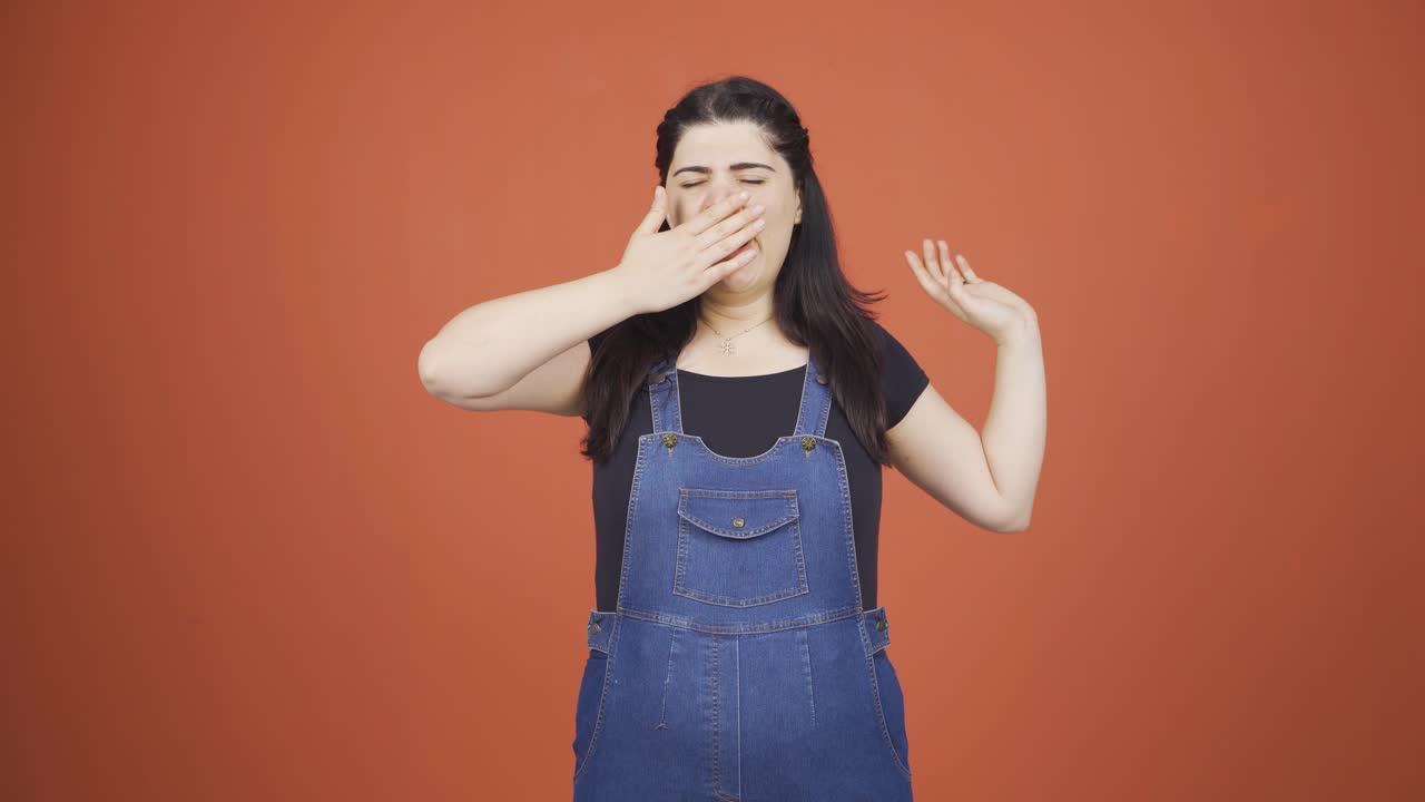 Sleepy woman yawns.