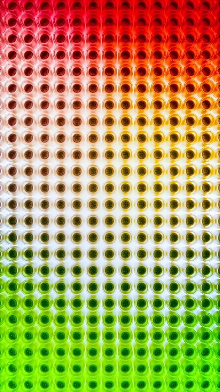 Color gradient transitioning, in digital display, with dots, from a neutral perspective, with white, red accents, and technological mood, showing nearby objects and surrounding setting.