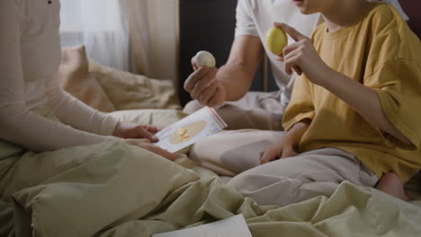 family celebrating easter in bed