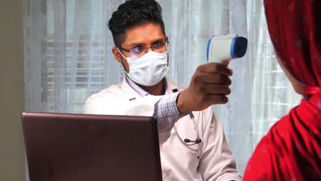 doctor checking patient's temperature