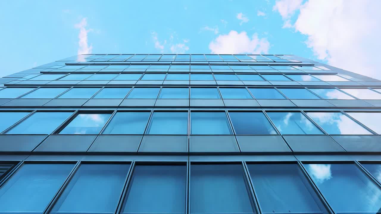 Modern office building with glass facade reflecting the sky