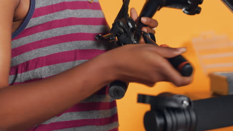 engineer uses screwdriver to tighten brake levers screws on bicycle handlebars