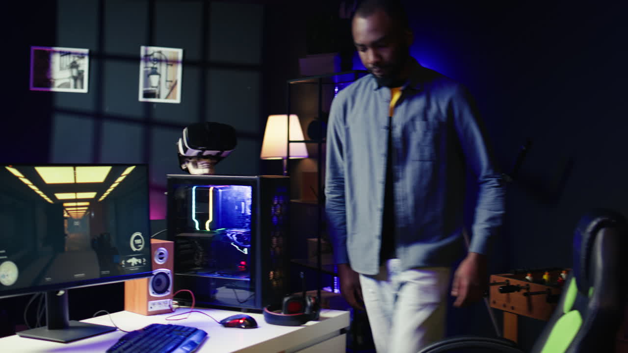 Man arriving at home to play FPS videogame on PC screen