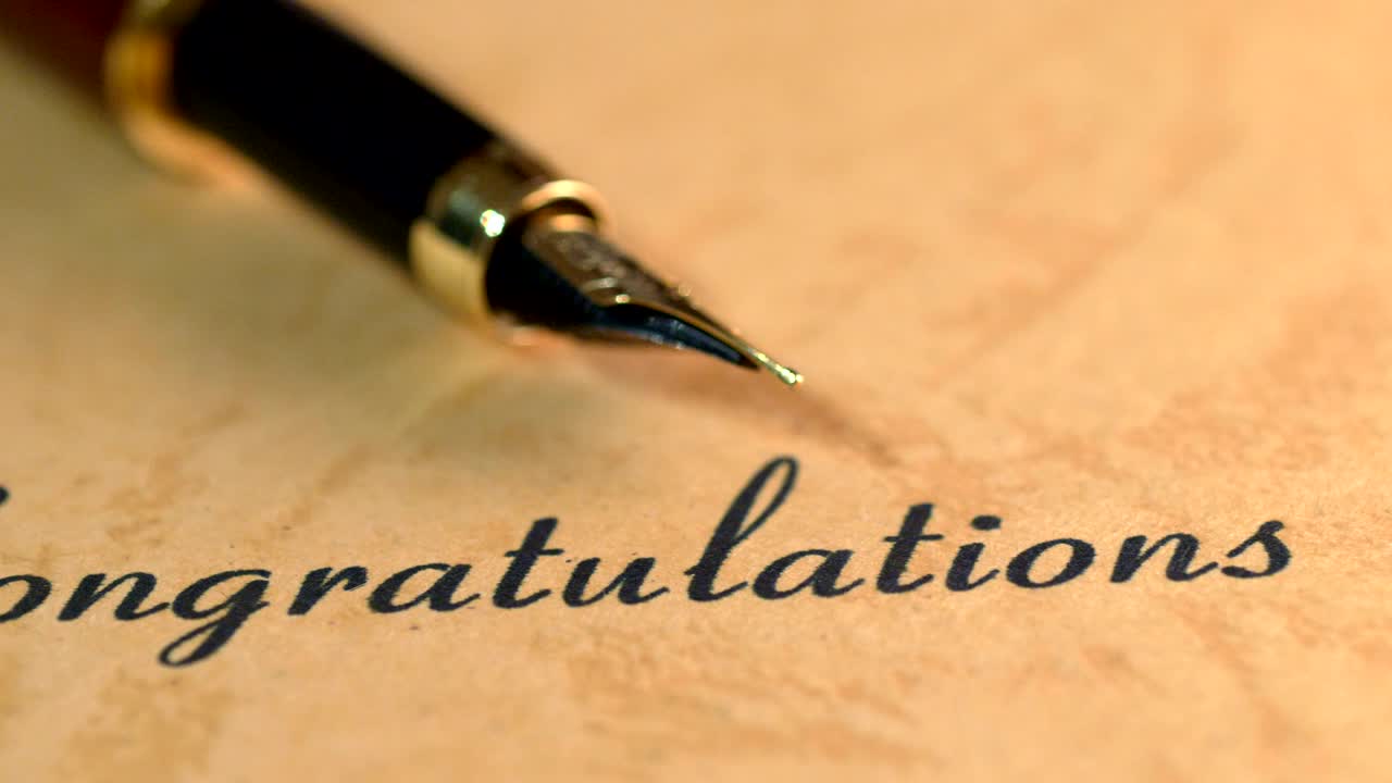 Fountain pen on congratulations text