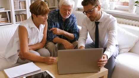 senior couple planning their investments with financial advisor on laptop