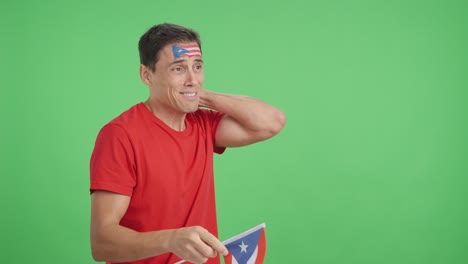 nervous man cheering for puerto rico during a match looking away
