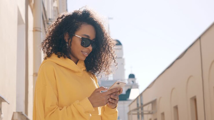 Woman using phone outdoors