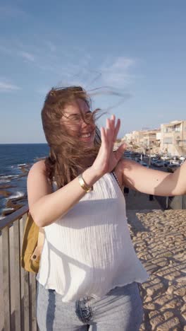 a woman is taking a picture of the sea with her cell phone in acre old city, israel