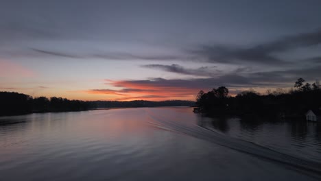 Sunrise-early-aerial-silhouette-over-Georgia-lake-with-boat