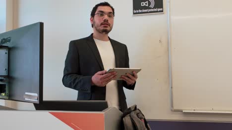 young man presenting with tablet device