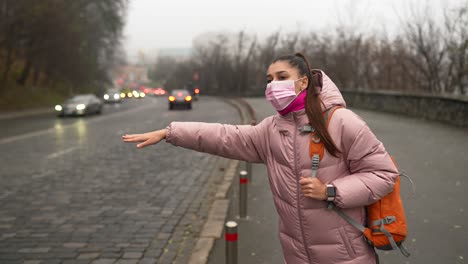 woman waiting for a taxi in the city