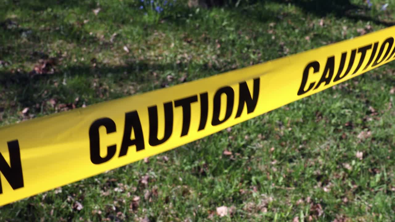 Warning for caution written on yellow ribbon