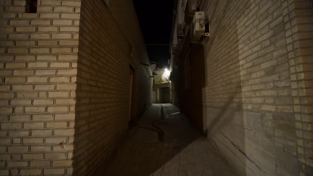 Dark and Narrow Brick Alley at Night