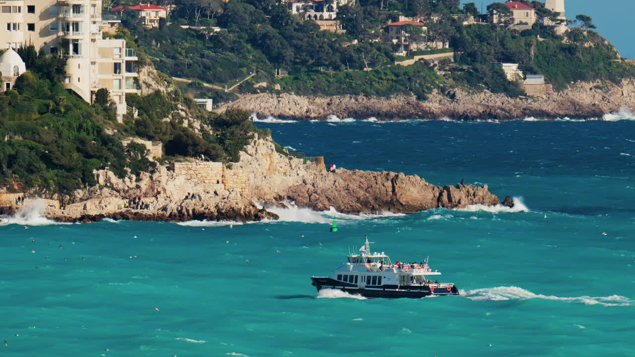 Nice, France - March 17, 2025: View of a boat moving on the blue sea near the coast in daylight