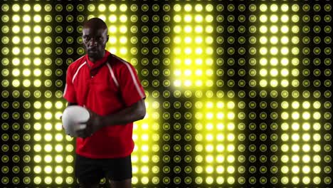 jugador de rugby profesional sosteniendo una pelota frente a una pantalla digital