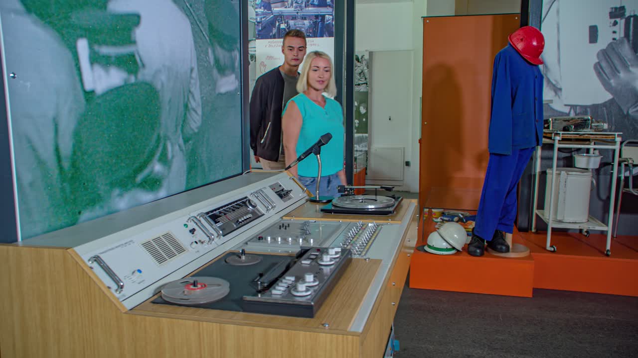 Woman and young man walking in ironmaking museum, Ravne na Koroskem, Slovenia