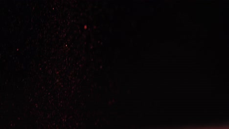 close-up of glitter falling against black background 4k