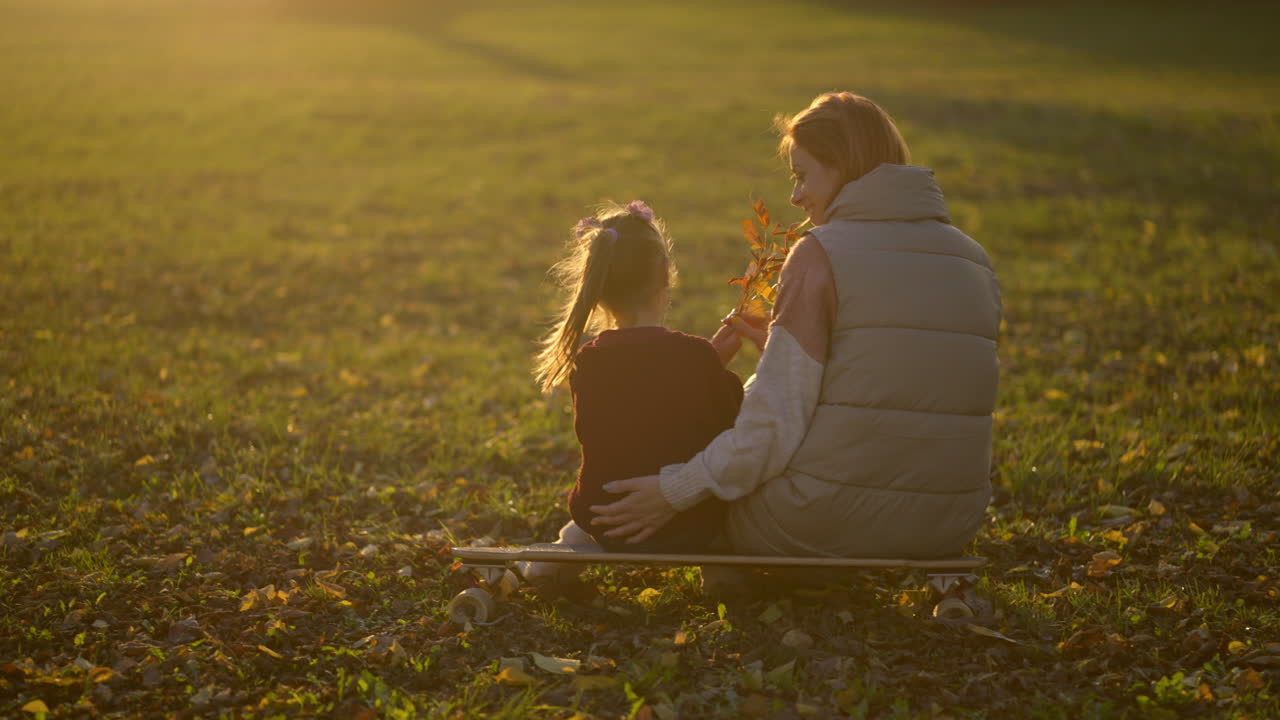 Mother and Daughter Enjoying a Sunset in the Park
