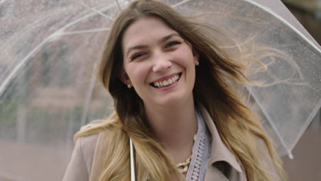 portrait of young happy blonde woman smiling confident holding umbrella enjoying cold rainy day