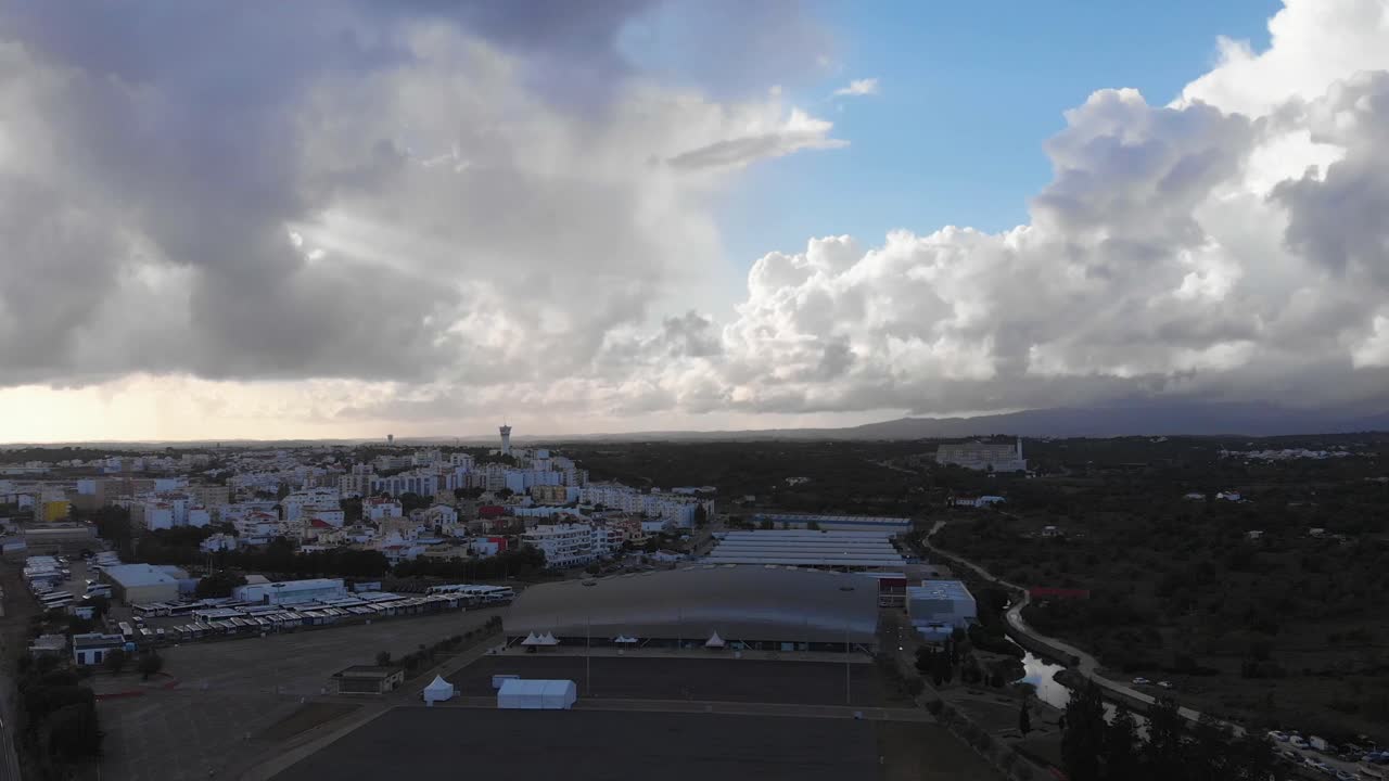 Aerial dolly flight showing city of Portimao in Portugal during dusk in the evening