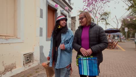 Two women walking and shopping on a street