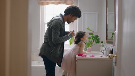 father brushing daughters hair in bathroom cute little girl getting ready in morning loving dad enjoying parenthood caring for child