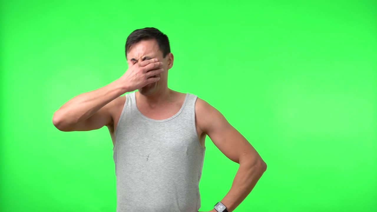 Man displaying a range of emotions on a green screen