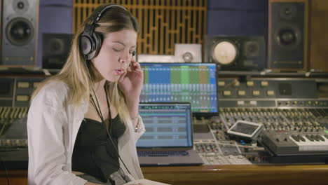 young caucasian woman working at music recording studio