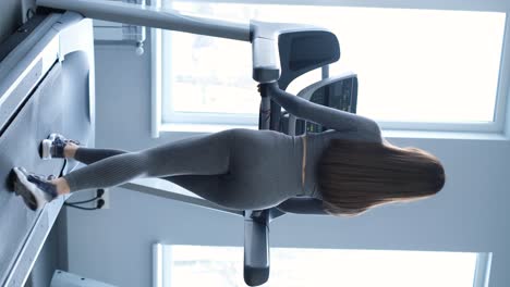 a young brunette girl works out on a treadmill in a gym active lifestyle sport concept a young brunette girl works out on a treadmill in a gym active lifestyle sport concept