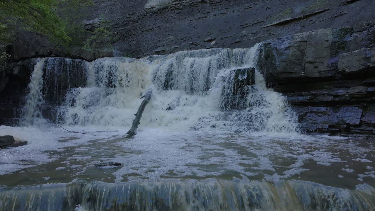 Waterfalls with flowing water and foam, surrounded by rocks in Ontario's nature