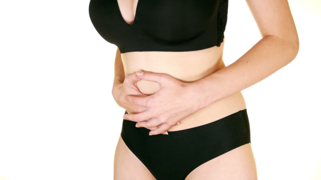 Close-up of a woman massaging her belly