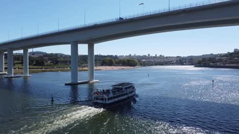 cruise passing under a bridge aerial view