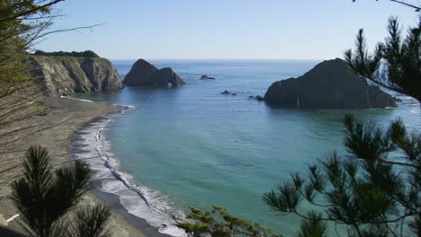 Rock-Formations-Off-Ocean-Waves-On-Shore-Landscape