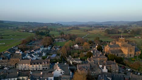Aerial-footage-of-the-Medieval-village-of-Cartmel-in-the-English-Lake-District-it-has-a-rich-heritage,-and-varied-list-of-activities-for-visitors-and-tourists