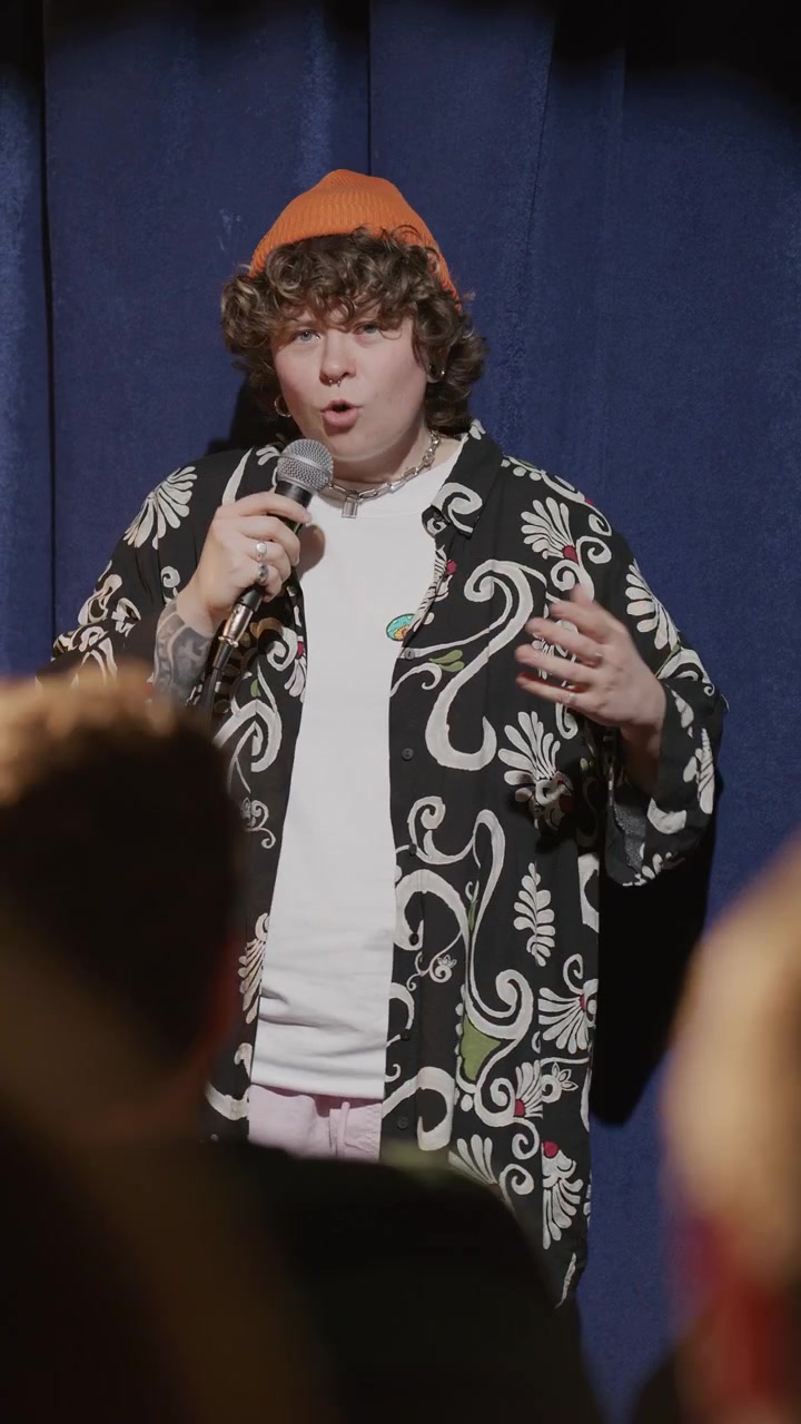 Charismatic Gen Z Comedian Performing Stand Up Set at Comedy Club