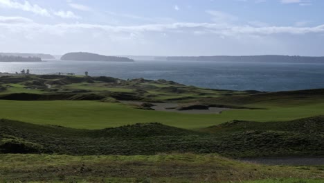 a sunny view of chambers bay golf course, ketron island, anderson island, and puget sound