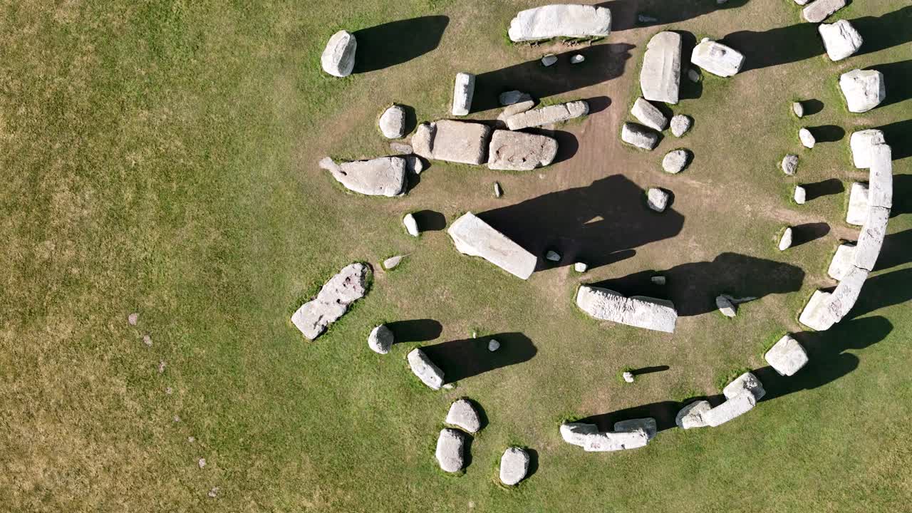 Ascending Overhead birds eye drone aerial view Stonehenge UK long shadows