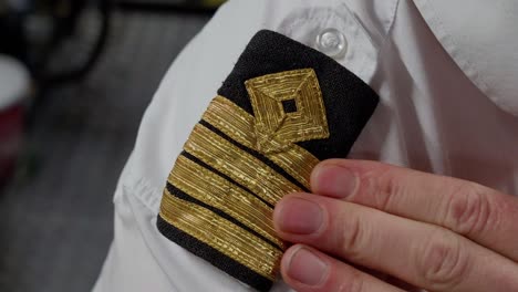 captain four striped shoulder epaulettes, close up