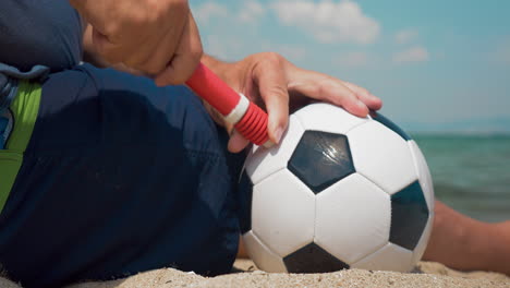 Hombre-Bombeando-Una-Pelota-De-Fútbol-En-La-Orilla