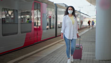 woman traveling by train wearing a mask